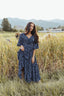 woman wearing bump friendly navy blue floral maxi dress with flowy sleeves and flowy skirt, perfect for bridal showers, weddings, church, baby showers, special events, easter and family photo shoots